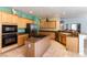 Spacious kitchen featuring wood cabinets, stainless appliances, and an island with gas cooktop at 3459 Ridge Meadow St, Las Vegas, NV 89135