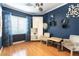 Bright living room with hardwood floors, modern decor, window with curtains, and furniture at 3459 Ridge Meadow St, Las Vegas, NV 89135
