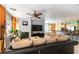 Open-concept living room with a fireplace, ceiling fan, and view of the kitchen and breakfast nook at 3459 Ridge Meadow St, Las Vegas, NV 89135