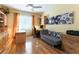 Home office featuring built-in shelving, desk space, hardwood floors, and a comfortable seating area at 3459 Ridge Meadow St, Las Vegas, NV 89135