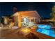 Covered patio with ample seating, a fire pit, and a sparkling pool provides ideal outdoor living space at 3459 Ridge Meadow St, Las Vegas, NV 89135