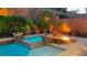 Inviting backyard pool with water features, fire pit, and lush landscaping, perfect for outdoor living at 3459 Ridge Meadow St, Las Vegas, NV 89135
