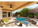 Covered outdoor pool and patio area, surrounded by lush landscaping and water features at 3459 Ridge Meadow St, Las Vegas, NV 89135