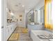Bright bathroom featuring double vanity, a soaking tub, and glass enclosed shower at 4050 Peaceful Dune St, Las Vegas, NV 89129