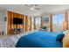 Large bedroom with comfortable blue bed, a flat screen tv and natural lighting at 4050 Peaceful Dune St, Las Vegas, NV 89129