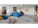Large primary bedroom with a chair and artwork, flooded with natural light at 4050 Peaceful Dune St, Las Vegas, NV 89129