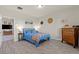 Inviting bedroom with wood-look floors, blue accents, decorative wall art, and dresser for a relaxing retreat at 4050 Peaceful Dune St, Las Vegas, NV 89129