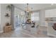 Bright dining area features wood-look floors, table with bench seating, and sliding glass doors to outdoor space at 4050 Peaceful Dune St, Las Vegas, NV 89129