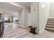 Hallway with hardwood flooring, accent furniture, and view into the kitchen and living areas at 4050 Peaceful Dune St, Las Vegas, NV 89129