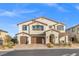 Stately two-story home with a three-car garage, manicured landscaping, and an inviting front entrance at 4050 Peaceful Dune St, Las Vegas, NV 89129