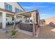 Relaxing backyard with a covered hot tub, seating, and well-maintained gravel landscaping for a serene outdoor experience at 4050 Peaceful Dune St, Las Vegas, NV 89129