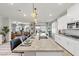 Spacious kitchen with granite counters, stainless appliances, and seating overlooking the living area at 4050 Peaceful Dune St, Las Vegas, NV 89129