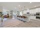Open kitchen features white cabinetry, granite counters, an island with seating and stainless appliances at 4050 Peaceful Dune St, Las Vegas, NV 89129