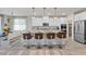 Kitchen with large island, seating, white cabinets and modern stainless steel appliances at 4050 Peaceful Dune St, Las Vegas, NV 89129