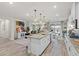 Bright, modern kitchen with an island, granite countertops, and an open floor plan at 4050 Peaceful Dune St, Las Vegas, NV 89129
