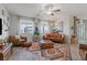 Inviting living room with stylish furniture, rug, large windows, ceiling fan, and decor for a cozy ambiance at 4050 Peaceful Dune St, Las Vegas, NV 89129