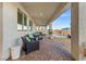Covered outdoor patio with comfortable seating and a view of the pool at 4050 Peaceful Dune St, Las Vegas, NV 89129