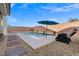 Private swimming pool features stepping stones, poolside seating, and tidy gravel landscaping for a resort-like feel at 4050 Peaceful Dune St, Las Vegas, NV 89129