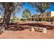 Two-story townhomes with well-maintained landscape featuring trees and mountain views in the background at 431 Las Casitas Way, Las Vegas, NV 89121