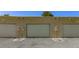 A set of garages with stucco walls and driveway at 431 Las Casitas Way, Las Vegas, NV 89121