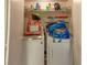 A small laundry area featuring a stacked washer and dryer with some storage space at 431 Las Casitas Way, Las Vegas, NV 89121