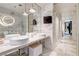 Modern bathroom featuring dual vessel sinks, marble countertops and tiling, and a glass-enclosed shower at 4381 W Flamingo # 2201, Las Vegas, NV 89103