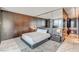 Modern bedroom featuring a large mirror wall, wood-paneled accent wall, and plush gray carpeting at 4381 W Flamingo # 2201, Las Vegas, NV 89103
