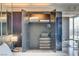 Walk-in closet with built-in storage, safe and open shelving adjacent to bedroom with city views at 4381 W Flamingo # 2201, Las Vegas, NV 89103