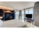 Bright main bedroom with floor-to-ceiling windows, modern closet and television, and soaking tub with city views at 4381 W Flamingo # 2201, Las Vegas, NV 89103