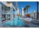 Resort-style pool with lounge chairs, palm trees, and views of luxury high-rise buildings at 4381 W Flamingo # 2201, Las Vegas, NV 89103