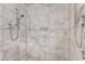 Detail of a shower with marble tiling and mounted shower products at 4381 W Flamingo # 2201, Las Vegas, NV 89103
