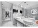 Lavish bathroom with marble walls, a double sink vanity, and a large mirror at 4381 West Flamingo Rd # 8322, Las Vegas, NV 89103