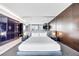 Sleek bedroom with dark wood accent wall and floor-to-ceiling mirrored headboard at 4381 West Flamingo Rd # 8322, Las Vegas, NV 89103