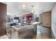 Open kitchen area featuring stainless steel island, modern appliances, and bar stool seating at 4381 West Flamingo Rd # 8322, Las Vegas, NV 89103