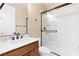 Bathroom featuring a vanity with dark wooden cabinets, white countertop, and glass enclosed shower at 441 Beautiful Hill Ct, Las Vegas, NV 89138