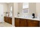 Cozy butler pantry with wooden cabinets, countertop space, a coffee station, and natural light from windows at 441 Beautiful Hill Ct, Las Vegas, NV 89138