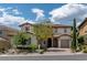 Beautiful two-story home with a brick driveway, mature trees, and well-maintained landscaping at 441 Beautiful Hill Ct, Las Vegas, NV 89138