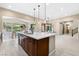 Spacious kitchen featuring a center island with a sink, stainless steel appliances, and an open layout at 441 Beautiful Hill Ct, Las Vegas, NV 89138