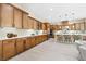 Spacious kitchen featuring wood cabinets, stainless steel appliances, a large island, and ample counter space at 441 Beautiful Hill Ct, Las Vegas, NV 89138