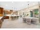 Stylish kitchen featuring a center island with bar stools, stainless steel appliances, and adjacent dining area at 441 Beautiful Hill Ct, Las Vegas, NV 89138