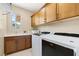 Laundry room with sink, cabinetry, and white front load washer and dryer at 441 Beautiful Hill Ct, Las Vegas, NV 89138