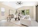 Bright, modern living room featuring neutral tones, a white sofa, and large windows with natural light at 441 Beautiful Hill Ct, Las Vegas, NV 89138