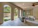 Covered outdoor living area with tiled floors and backyard access at 441 Beautiful Hill Ct, Las Vegas, NV 89138
