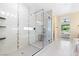 Bright primary bathroom with glass enclosed walk-in shower with seat and tile surround at 441 Beautiful Hill Ct, Las Vegas, NV 89138