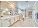 Bright bathroom showcases a large mirror, dual sinks, glass shower, and a walk-in closet at 4680 Peppertree St, Pahrump, NV 89061