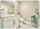 Well-lit half bathroom with modern fixtures, neutral tones, and gray wood-look floors at 4680 Peppertree St, Pahrump, NV 89061