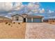 Charming single-story home with a desert landscape and a paved driveway leading to a two-car garage at 4680 Peppertree St, Pahrump, NV 89061