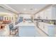 Bright kitchen with white cabinets, stainless steel appliances, and a large center island with barstool seating at 4680 Peppertree St, Pahrump, NV 89061