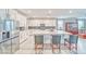 Bright kitchen with white cabinets, stainless steel appliances, and a large center island with barstool seating at 4680 Peppertree St, Pahrump, NV 89061