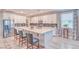 Bright kitchen with white cabinets, stainless steel appliances, and a large center island with barstool seating at 4680 Peppertree St, Pahrump, NV 89061
